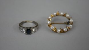A 14 carat yellow gold and cultured pearl wreath brooch set with nine round cultured pearls, stamped