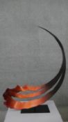 A large copper effect abstract curl steel sculpture on rectangular base. Indistinctly signed and