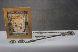 A framed painted plastic tile effect picture of Punch and Judy along with two horse brasses and fire