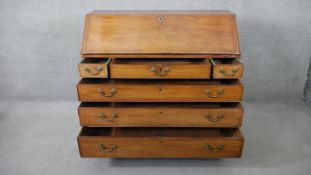 A Georgian mahogany bureau with fall front revealing satinwood and olivewood inlaid interior above