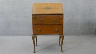 A mid century light oak carved bureau. H.100 W.61 D.38 cm