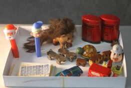 A collection of vintage toys. Including Pez dispensers, two miniature tin plate post boxes with