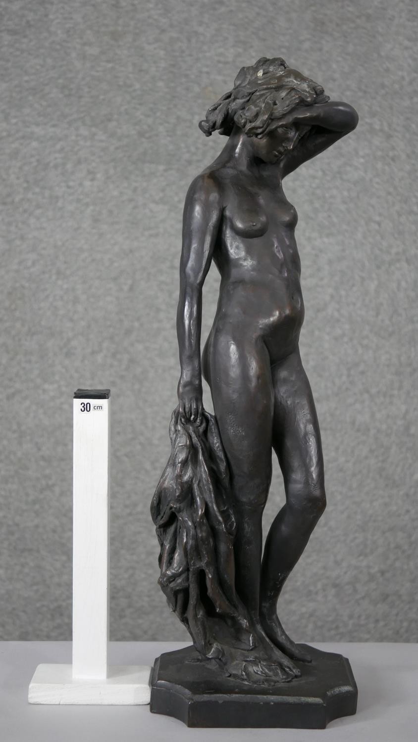 Ron Moll- A contemporary bronzed cold cast resin figure of a nude woman holding a cloth. Signed R. - Image 2 of 6