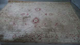A Ziegler carpet with flowerhead design across the field within complementary multiple borders. L.