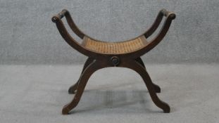 A 19th century X framed stool with caned seat. H.50 W.62 D.35 cm