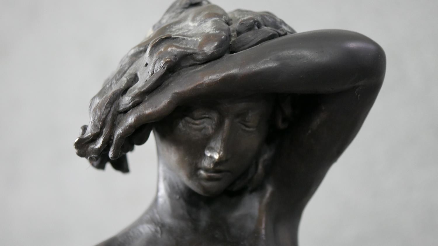 Ron Moll- A contemporary bronzed cold cast resin figure of a nude woman holding a cloth. Signed R. - Image 3 of 6