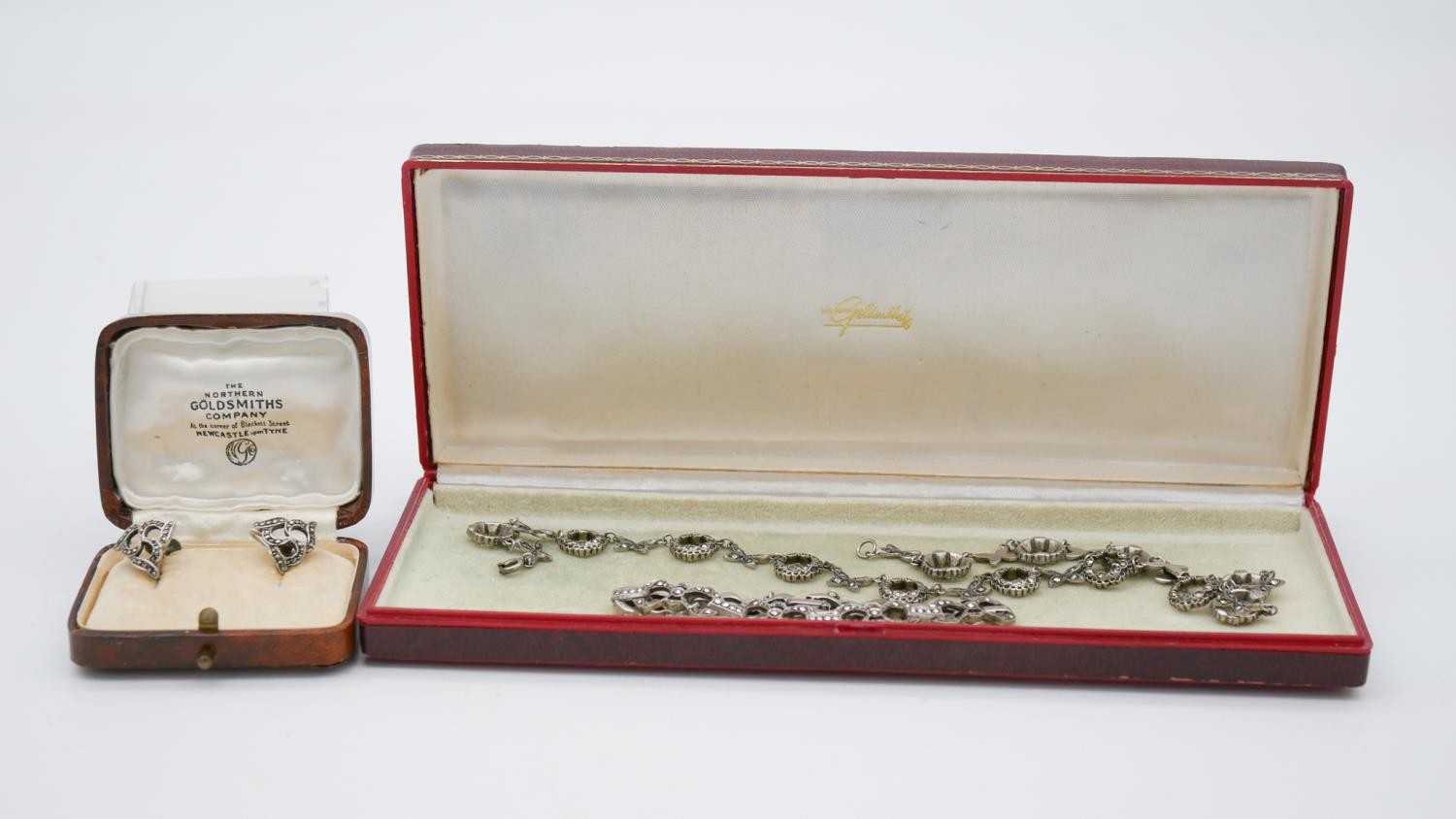 A collection of Art Deco silver and marcasite jewellery. Including an articulated floral design