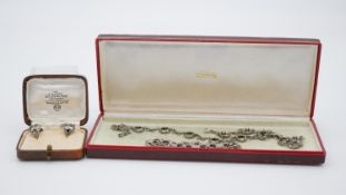 A collection of Art Deco silver and marcasite jewellery. Including an articulated floral design