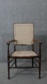 An Edwardian stained beech open armchair.