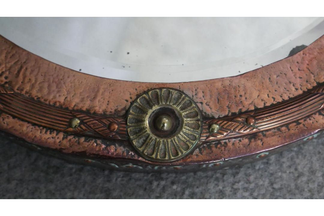 A C.1900 copper and brass hammered wall mirror with bevelled plate. H.37 W.42cm - Image 5 of 6