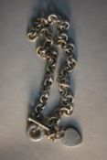 A Tiffany silver chain link necklace with heart pendant and T-bar, stamped Tiffany & Co.