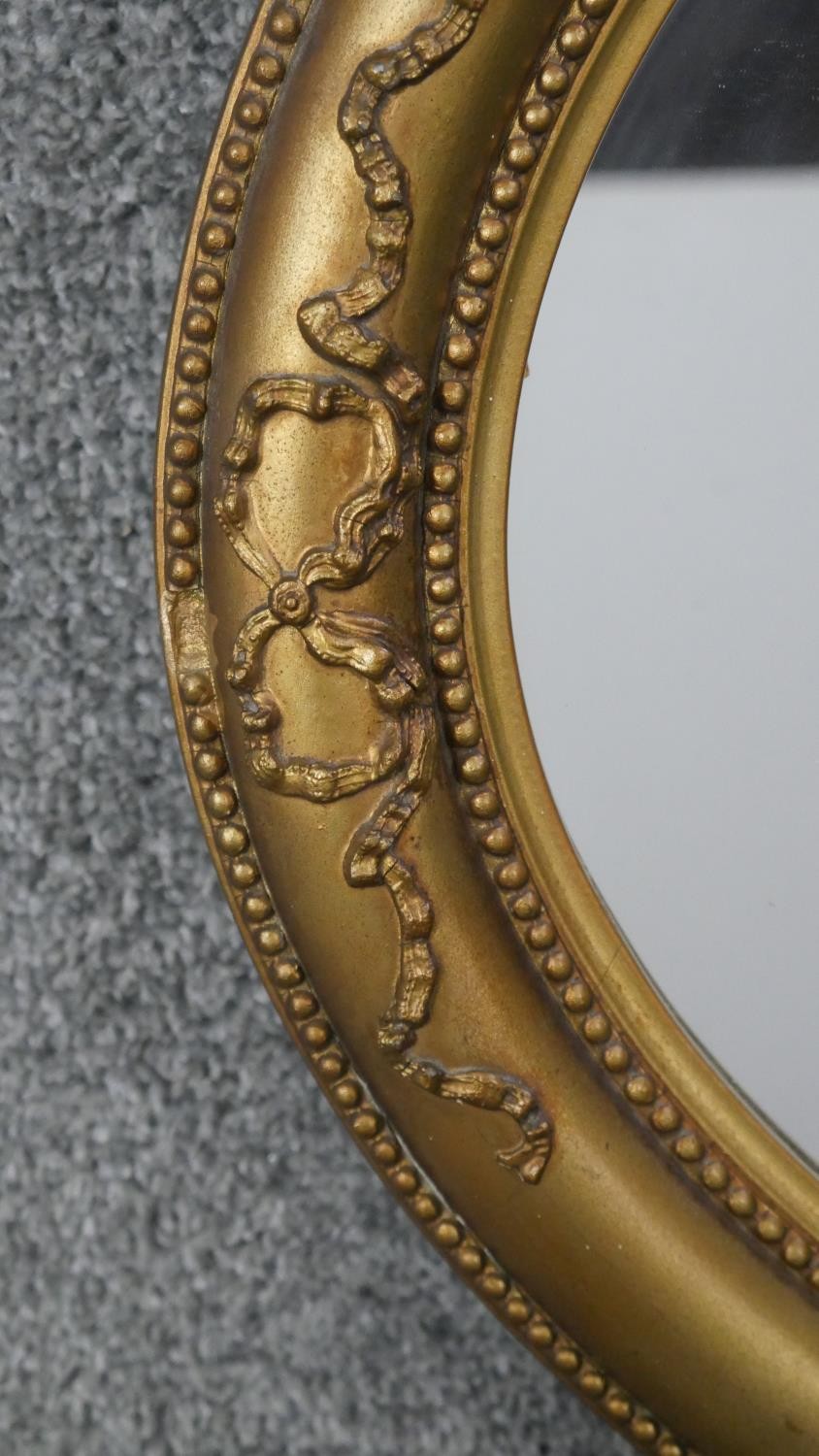 A C.1900 oval wall mirror in gilt ribbon and beaded gesso frame. H.50 W.78cm - Image 3 of 5