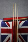WITHDRAWN - A cased snooker cue, three others and a Union Jack.