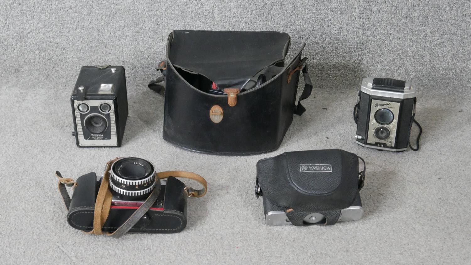 A collection of vintage cameras. Including a Yashika, Praktika super TFL and two vintage brownie