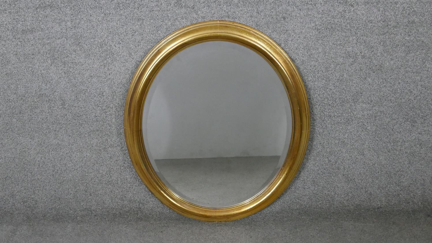 An oval gilt framed mirror. H.71 W.61cm