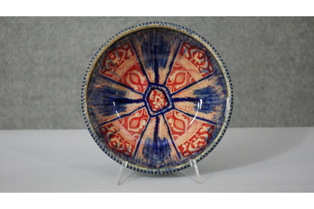 A Persian glazed ceramic bowl, the interior decorated with floral motifs, marked and dated to - Image 1 of 7