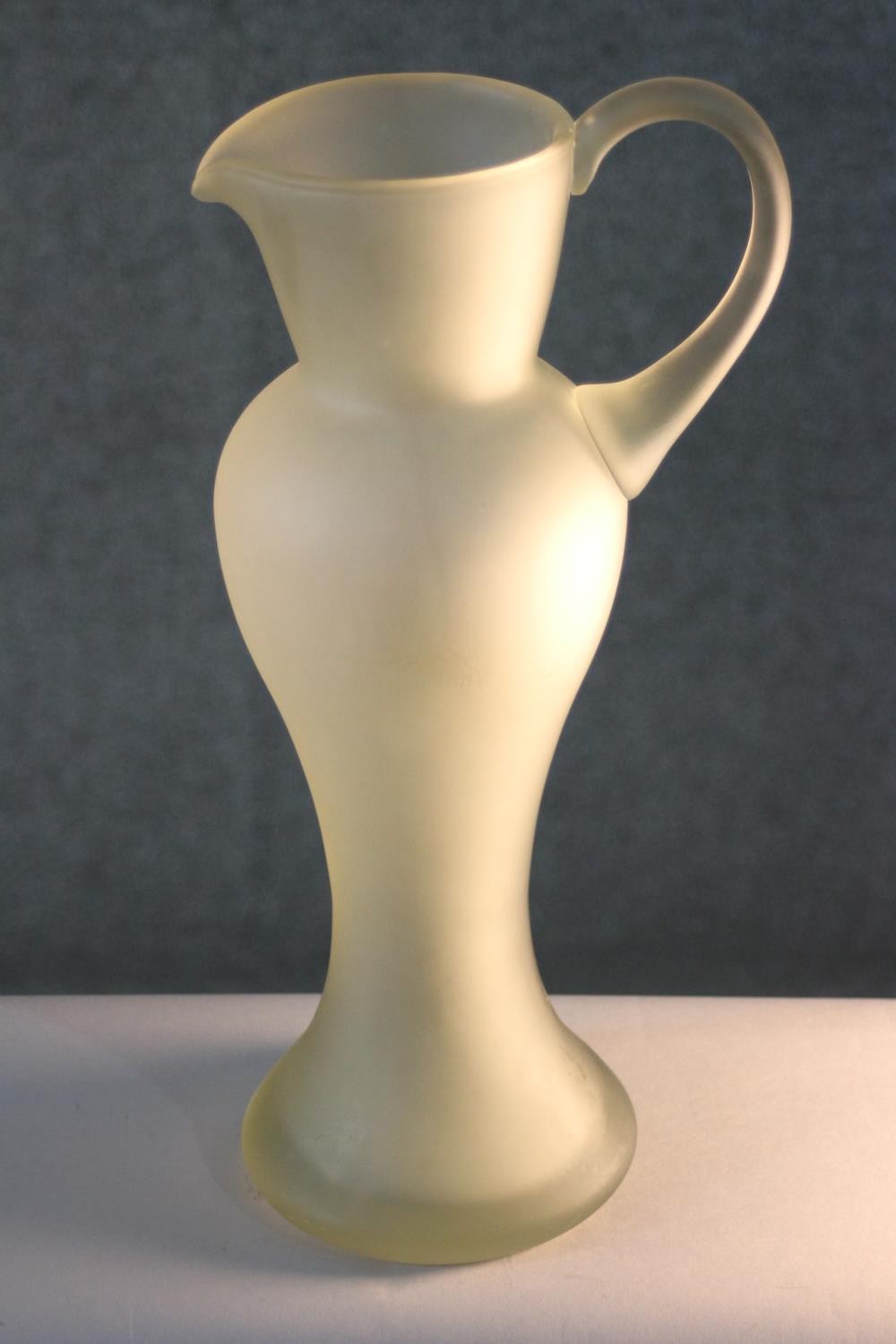 A vintage hand blown frosted clear art glass jug of elongated form. H.39 W.18 D.14cm.