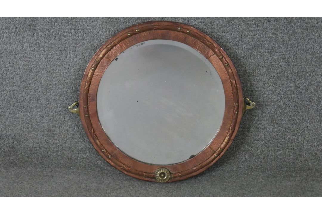 A C.1900 copper and brass hammered wall mirror with bevelled plate. H.37 W.42cm - Image 1 of 6