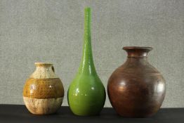 A large turned hardwood baluster vase along with a stoneware jug with incised decoration and a green
