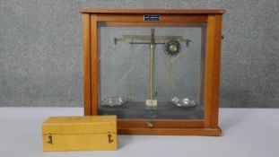 A Griffin & George Limited scientific scale, with chrome pans, in glazed case. With a boxed set of
