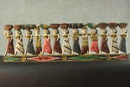 A carved, pierced and painted polychrome wall hanging. H.30 W.90 cm.