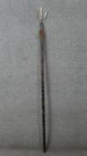 A Polynesian hardwood and metal ceremonial staff with trident and animal hair detail. Carved