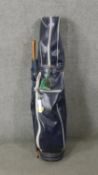 A full set of irons and woods in leather effect gold bag. H.111 W.30 D.36cm