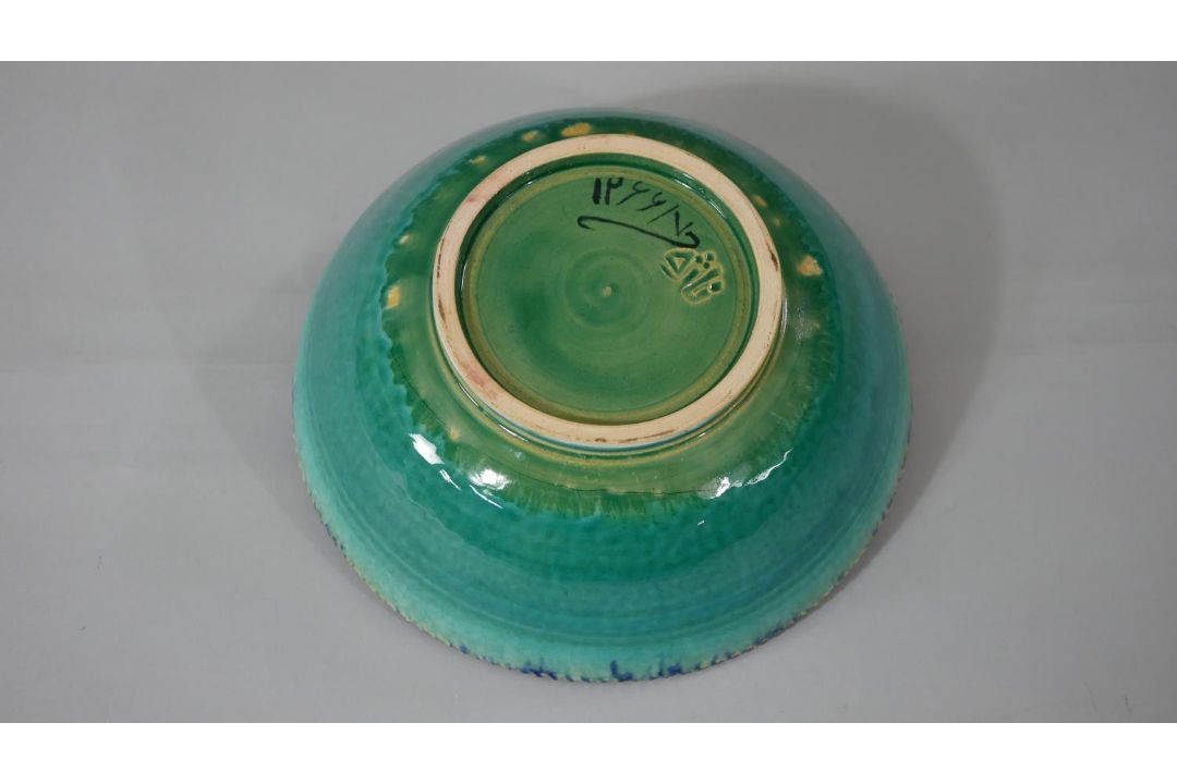 A Persian glazed ceramic bowl, the interior decorated with floral motifs, marked and dated to - Image 4 of 7
