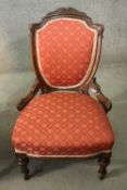 A late 19th century carved mahogany salon chair in geometric floral upholstery on tapering fluted