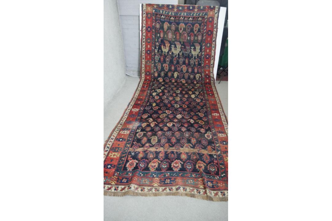 A large Kurdish runner with repeating motifs across the midnight ground within stylised multiple - Image 1 of 5