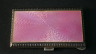 An Art Deco silver and pink guilloche enamel card case with engine turned decoration. Hallmarked: