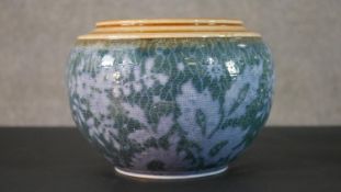 A early 20th century Doulton Lambeth glazed ceramic planter with stylised floral and foliate design.