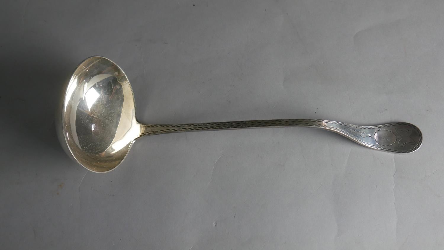 A 19th century engraved silver plated ladle with angled handle. Hallmarked WH, L.32 W.11cm Weight