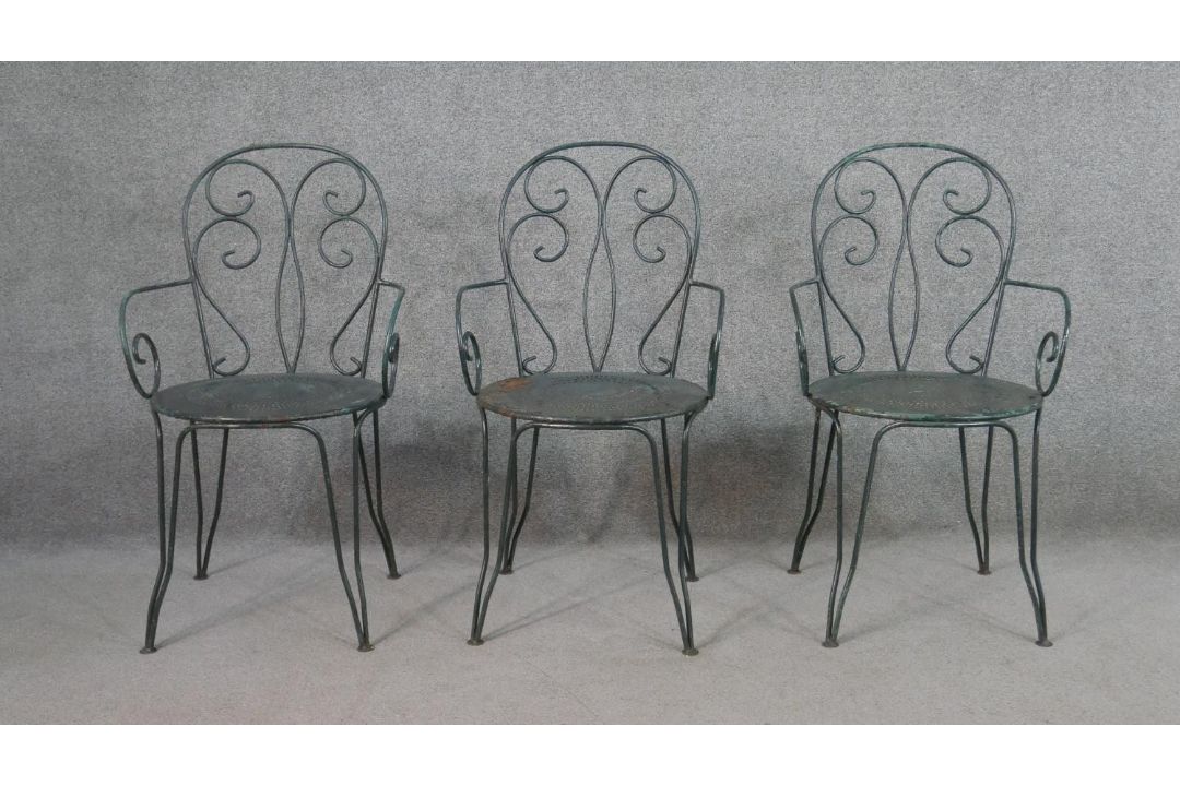 A set of three wrought iron garden chairs, with scrollwork to the back and arms, on a circular - Image 1 of 5