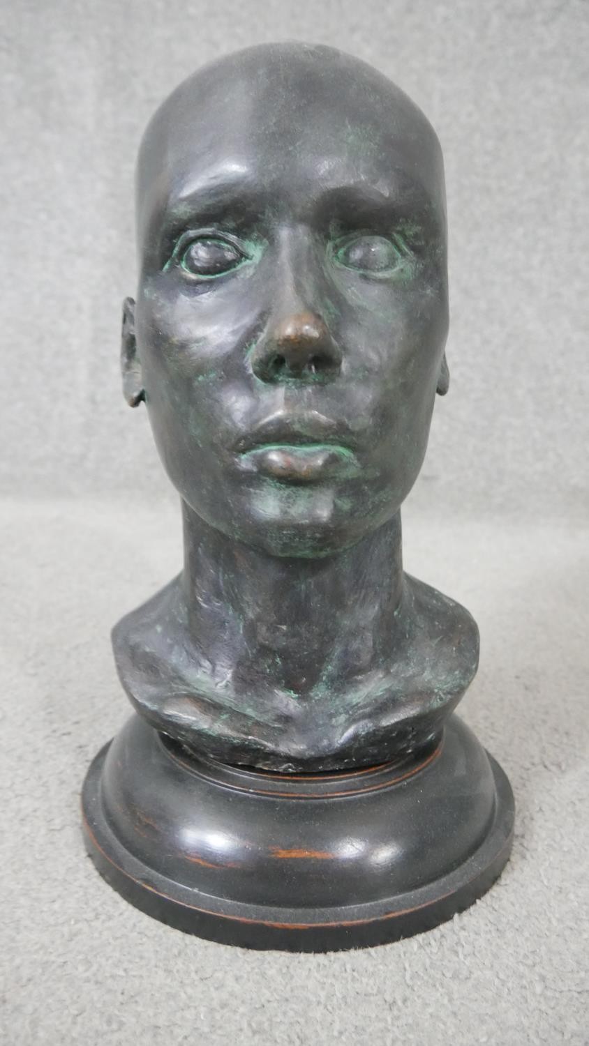 An early 20th century bronze head mounted on a turned ebonised base. H.38 W.20cm