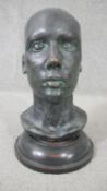 An early 20th century bronze head mounted on a turned ebonised base. H.38 W.20cm
