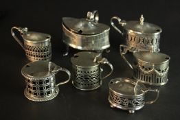 Seven 19th and 20th century sterling silver pierced design hinged lid mustard pots, various designs,