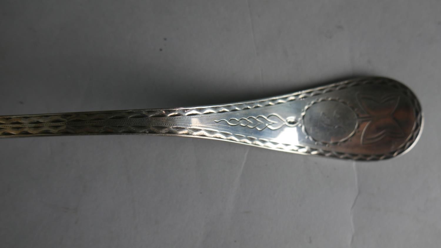 A 19th century engraved silver plated ladle with angled handle. Hallmarked WH, L.32 W.11cm Weight - Image 3 of 4