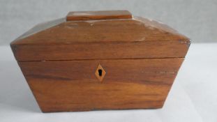 A Victorian mahogany sarcophagus shape box with with twin brass lion head handles. H.12 W.20cm