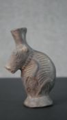 A pre-Colombian style clay vase in the form of an armadillo with relief design. H.16 W.11cm
