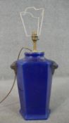 A cobalt blue glaze ceramic lamp with relief lionhead motifs. H.65 Diam.45cm