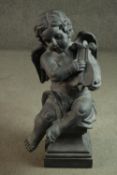 A clay statue of a Cherub playing a lyre on a pedestal base. H.73cm.