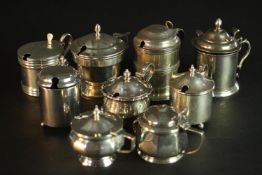 Nine sterling silver hinged lid mustard pots, various designs, makers and assay marks. (9pcs).