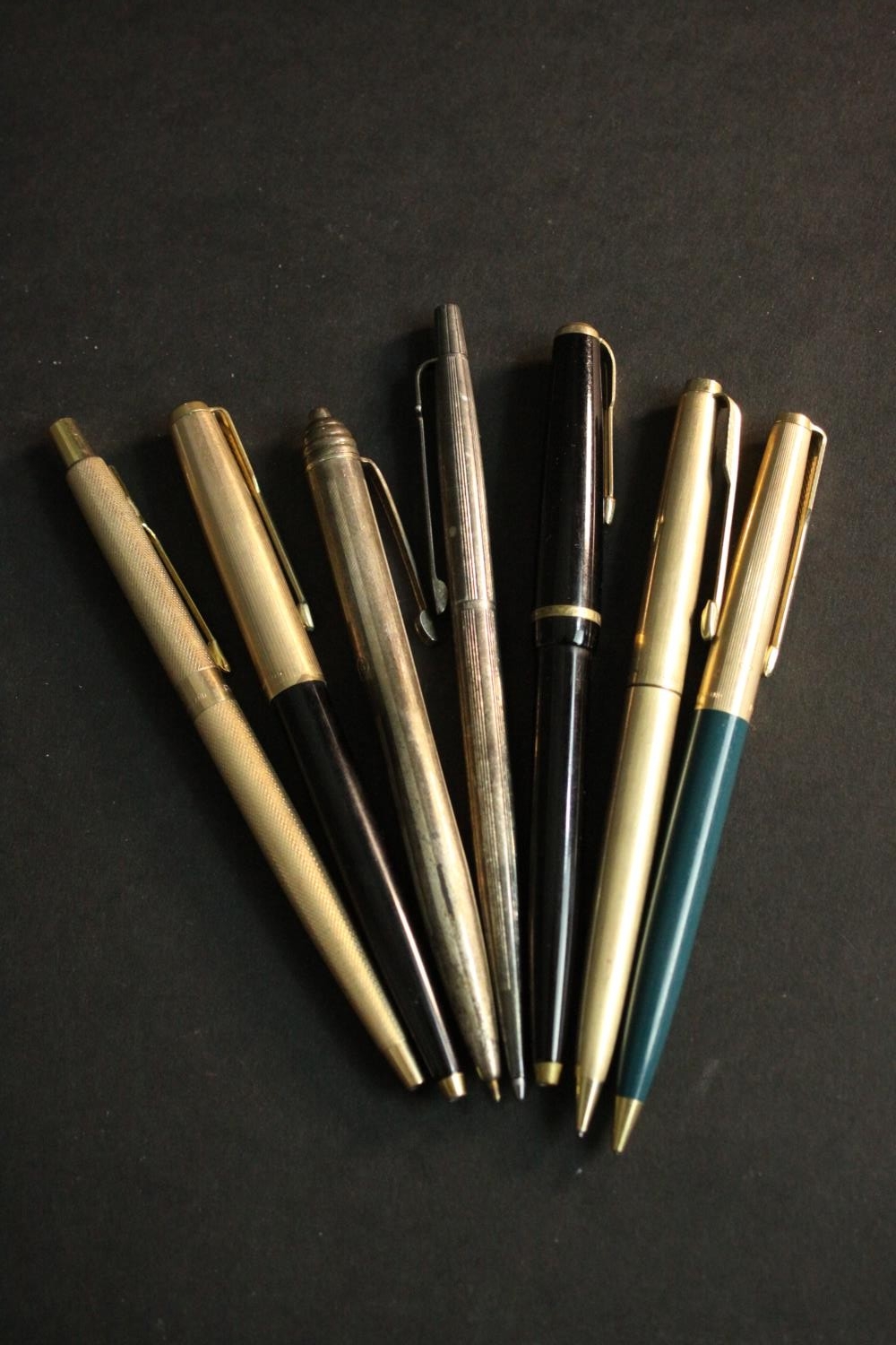 A collection of seven ballpoint and fountain pens, silver and gold plated, various makers such as