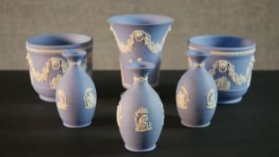 A collection of six Wedgwood Jasperware pieces, a vase, two planters with Classical design and three