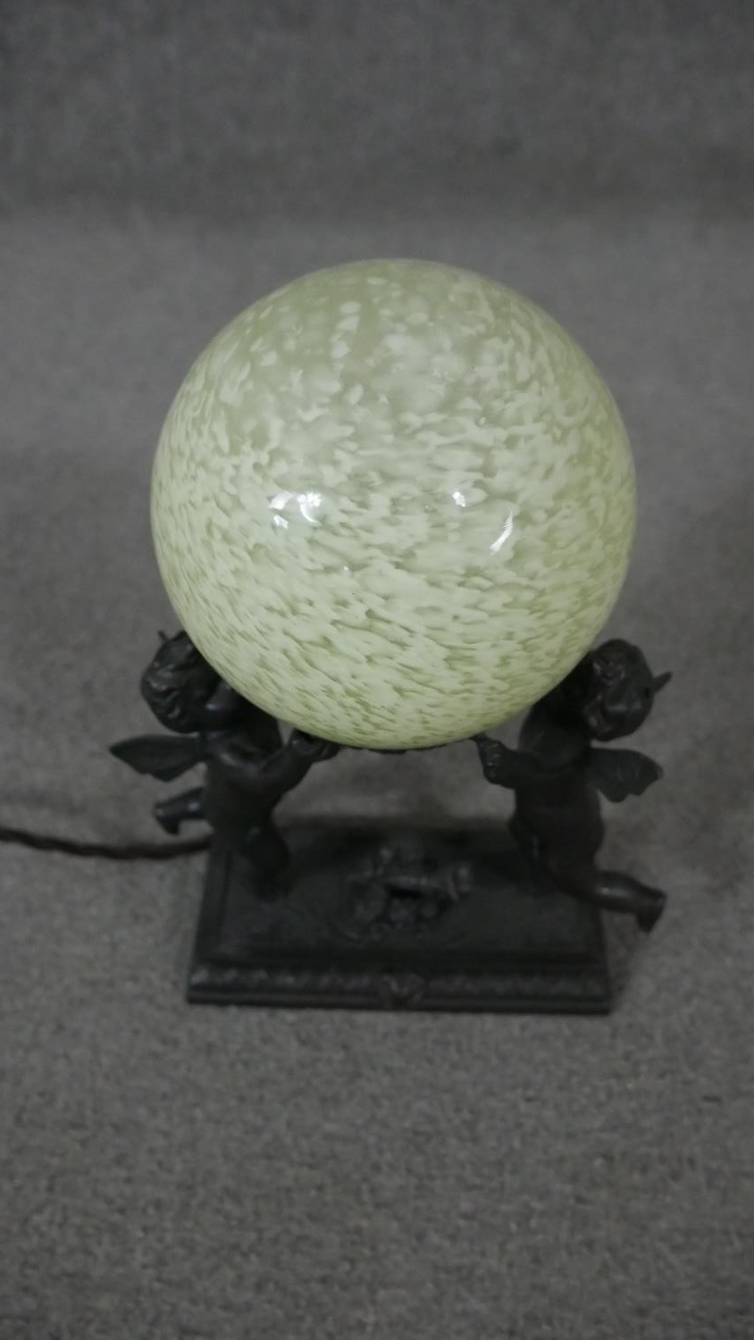 A bronze effect classical design table lamp of two cherubs holding a pale green marbled glass - Image 2 of 4