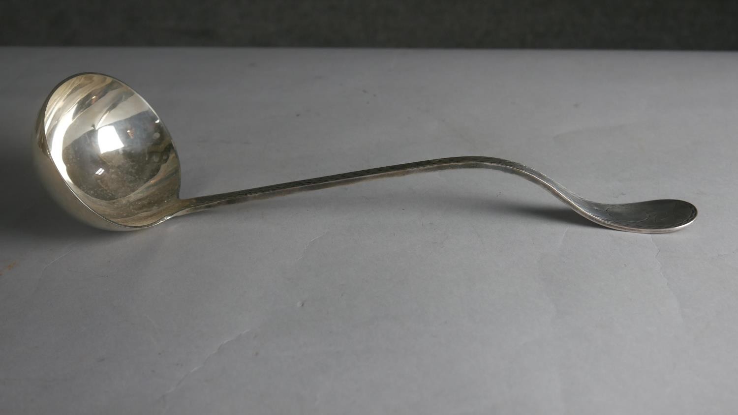 A 19th century engraved silver plated ladle with angled handle. Hallmarked WH, L.32 W.11cm Weight - Image 2 of 4