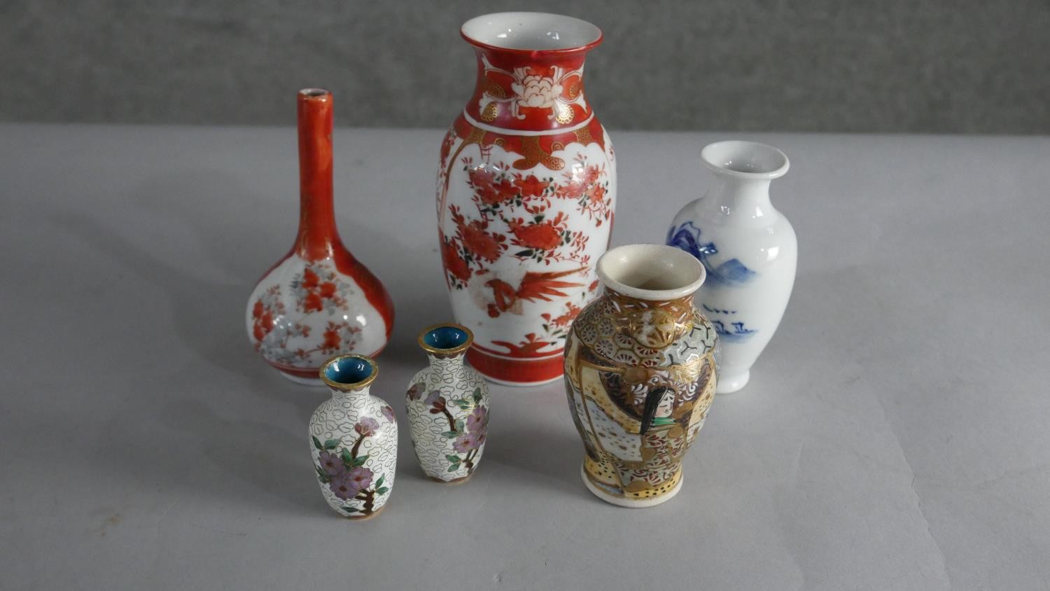 A collection of Oriental vases, including a pair of cloisonné enamel vases, a blue and white