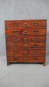A stained pine collectors cabinet, the six long drawers with brass ring handles and fitted