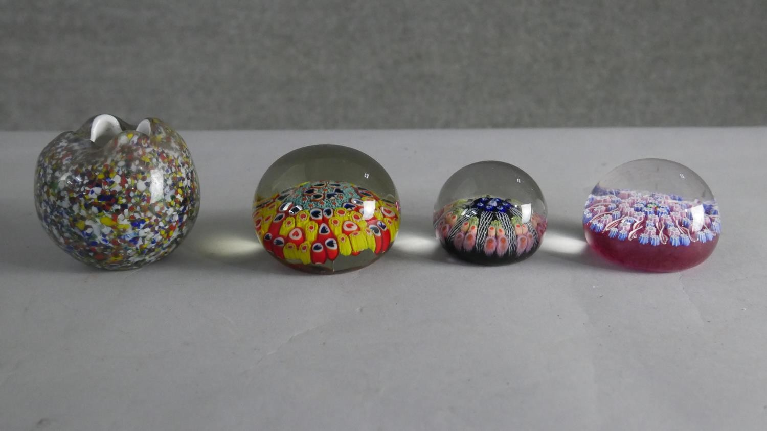 Three art glass lamp work paper weights and a pinched design Murano glass vase.